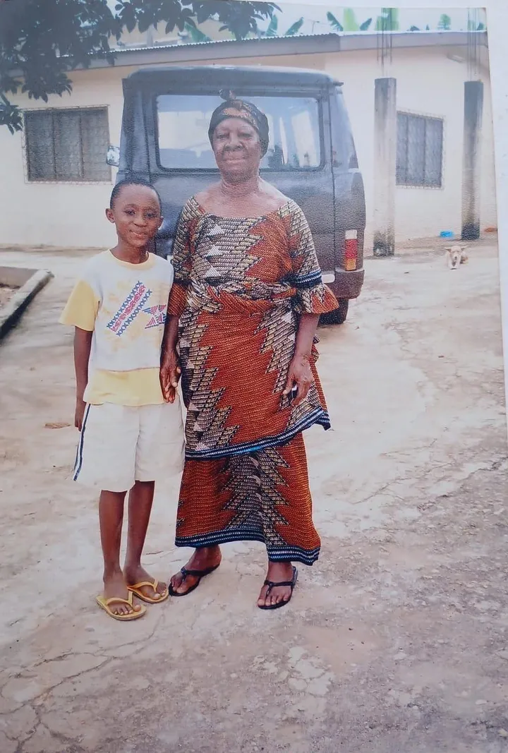 A child and an older woman standing together outdoors.